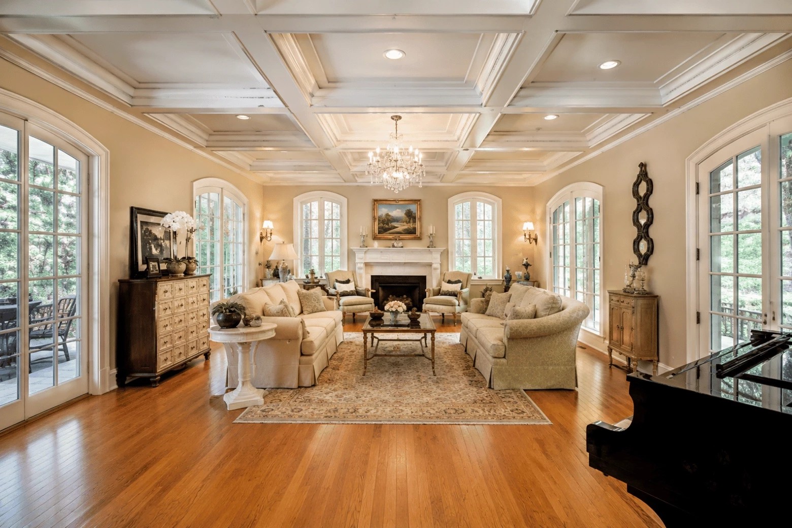 Traditional living room with white box-beam coffers, layered crown moulding, and recessed lights