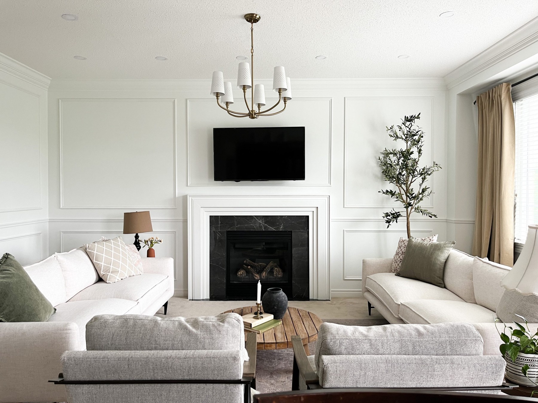 White full-height picture-frame wall moulding with upper and lower rectangular panels, chair rail, and crown moulding